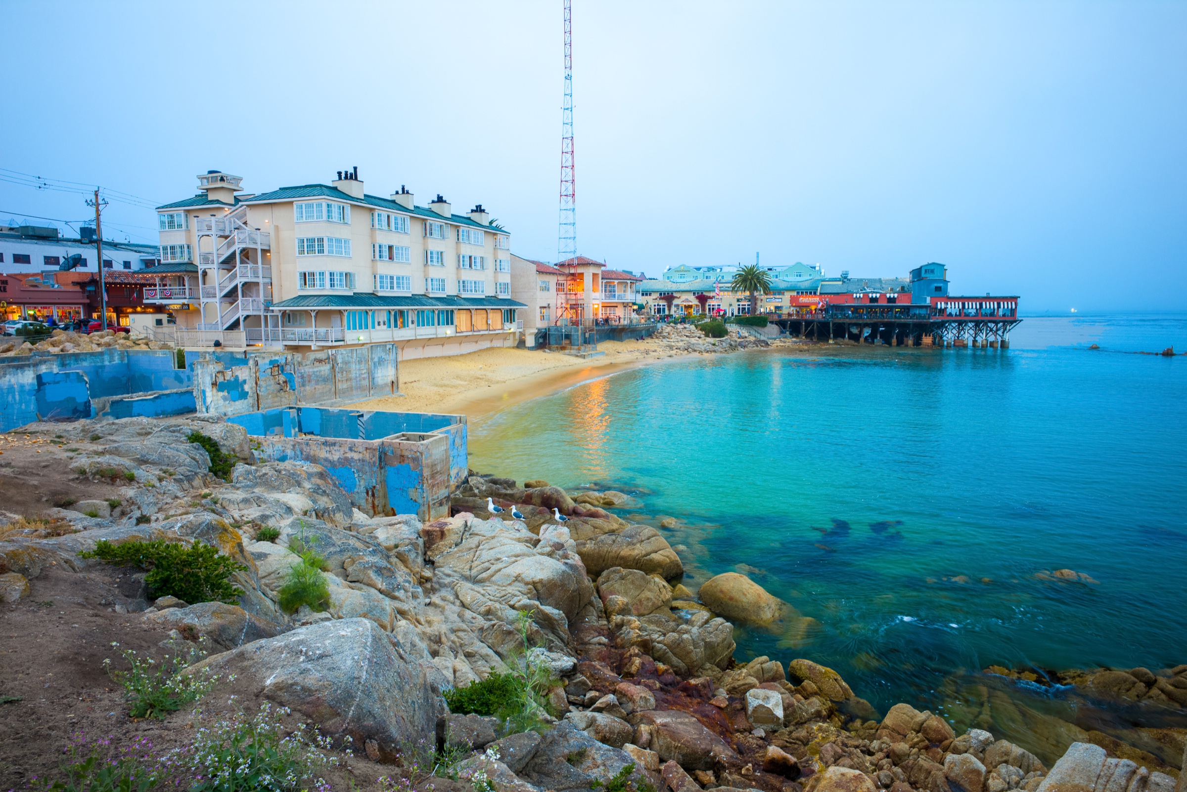 Cannery Row waterfront buildings, rocky shore, and Monterey Bay